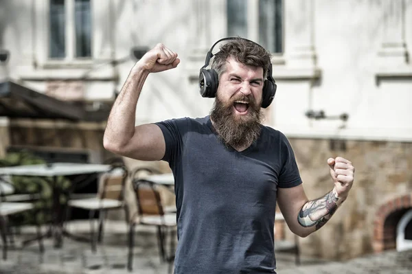 Enjoy free songs everyday. Excellent music in his playlist. Man bearded hipster with headphones listening music. Hipster enjoy high quality sound of song in headphones. Get music subscription