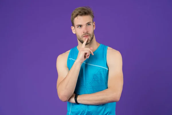 Let me think. Man with strong muscular arms. Man muscular handsome unshaven thoughtful guy on violet background. Masculinity concept. Does having muscular body make you more confident. Remember date