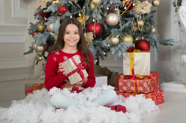 Little child girl likes xmas present. Christmas. Kid enjoy the holiday. Happy new year. small happy girl at christmas. The morning before Xmas. New year holiday. Winter holidays sales. boxing day — Stock Photo, Image