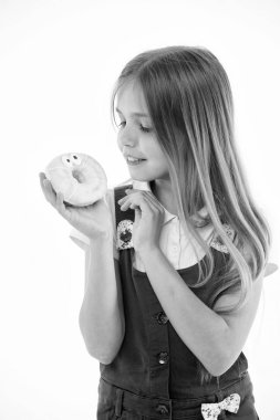 Tatlılar çocuklarınız için ne kadar kötü. Kız sevimli gülümseyen yüzü tatlı çörek tutar. Kız tatlı çörek seviyor. Ödüller ile şeker kaçının. Çocuk iyi halden şekerli muamele etmek ile ödüllendirilir