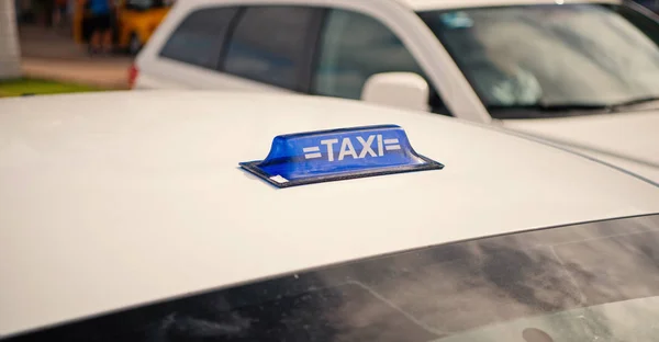 Taxi top sign on white cab roof — Stock Photo, Image