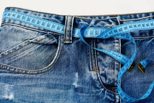 Making clothes and design concept: measure tape used as belt — Stock Photo, Image