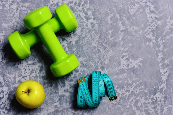 stock image Sports and training. Tape measure and fruit near barbell.