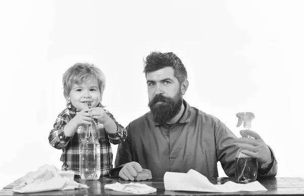 Guy with beard and mustache in rubber gloves at table.