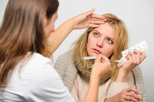 Woman consult with doctor. Doctor communicate with patient recommend treatment. Doctor ask patient about symptoms. Flu and cold treatment. Girl in scarf examined by doctor. Cold and flu remedies — Stock Photo, Image