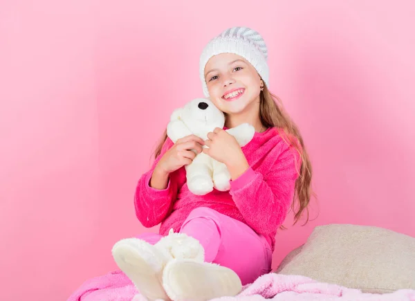 Teddy bears improve psychological wellbeing. Kid little girl play with soft toy teddy bear pink background. Child small girl playful hold teddy bear plush toy. Unique attachments to stuffed animals.