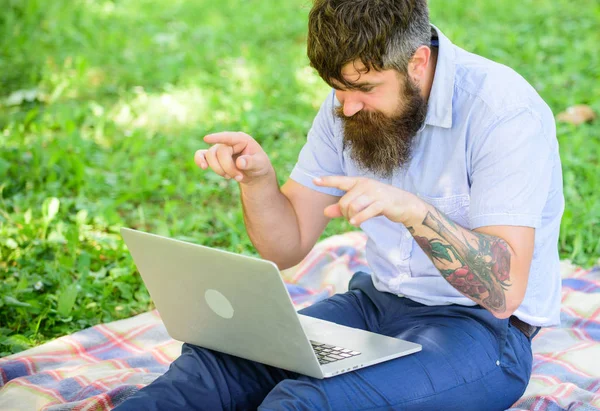 Man bearded with laptop sit meadow nature background. Writer looking for inspiration nature environment. Inspiration for blogging. Looking for inspiration. Blogger becoming inspired by nature
