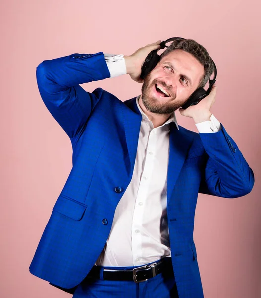 Man bearded face formal suit enjoy song. Playlist for office work. Music break during working day. Business man with headphones listening music. Businessman listen music and dance. Music and relax