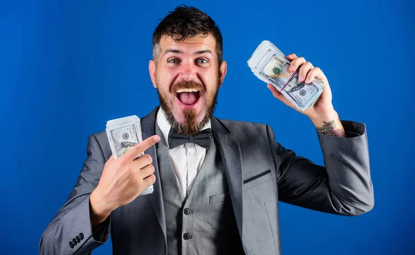 Get cash easy and quickly. Cash transaction business. Man happy winner rich hold pile of dollar banknotes blue background. Easy cash loans. Win lottery concept. Businessman got cash money — Stock Photo, Image