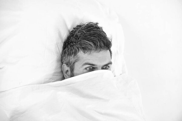 Nightmare and fear concept. Man wants to stay in bed