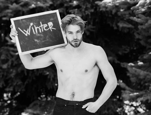 Handsome muscular man with winter blackboard outdoor — Stock Photo, Image