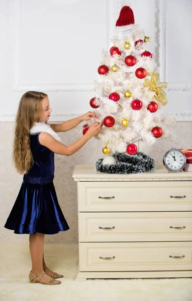 Spread christmas cheer. Kid happy because holiday season arrives. Winter holiday concept. Very special time of year. Family holiday concept. Girl velvet dress feel festive near christmas tree — Stock Photo, Image
