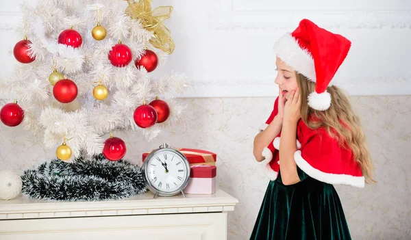 New year countdown. Last minute new years eve plans that are actually lot of fun. Girl kid santa hat costume with clock counting time to new year. How much time before. Last minute till midnight