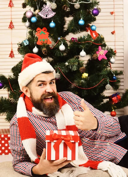 Celebration and gift concept. Man with beard holds present box — Stock Photo, Image