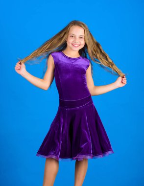 Uzun saçlı çocuk kız mavi arka plan üzerinde elbise giymek. Dansçı için saç modeli. Nasıl çocuk için düzenli saç modeli yapmak. Balo salonu dans saç modeli hakkında bilmen şey. Balo Salonu latin dans saç modelleri