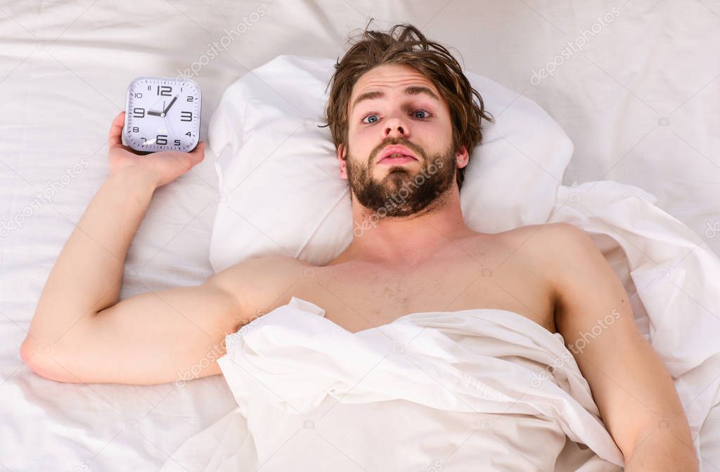 Handsome man yawning and stretching his arms up. Cheerful young man is waking up after sleeping in the morning. The routine