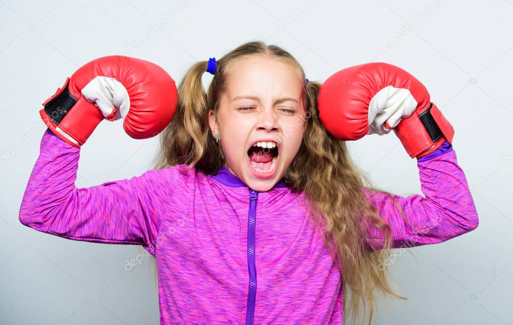 Girl cute child with red gloves posing on white background. Upbringing for leader. Strong child boxing. Sport and health concept. Boxing sport for female. Sport upbringing. Skill of successful leader