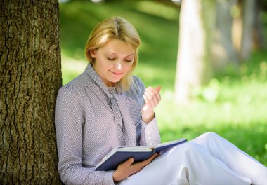 Boş zaman bir hobi kavramı relax. En iyi kendi kendine yardım kitapları kadınlar için. Kitaplar her kız okumalısınız. Kız konsantre sit park yalın ağaç gövdesi kitabını okudum. Kitap ilham okuma. Üst liste bestseller