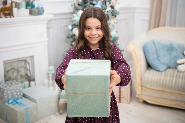 little child girl likes xmas present. Christmas. Kid enjoy the holiday. Happy new year. small happy girl at christmas. The morning before Xmas. New year holiday. Opening her Christmas present