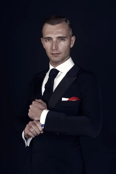 Man in a black tuxedo suit and white shirt — Stock Photo, Image