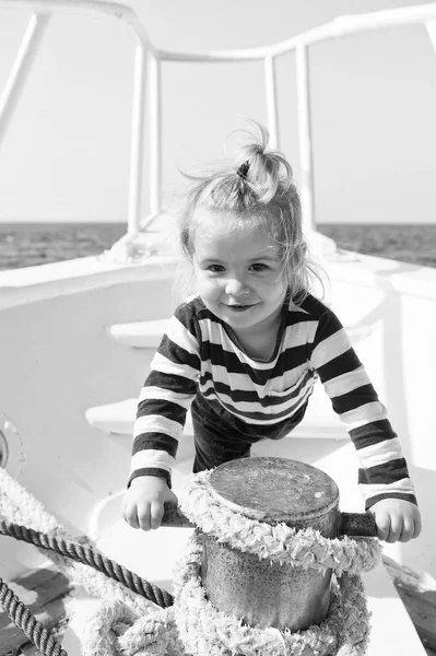 Mooring ship. Child cute sailor help with ropes yacht bow. Adventure boy sailor travelling sea. Baby boy enjoy vacation on cruise ship. Boy adorable sailor striped shirt yacht travel around world