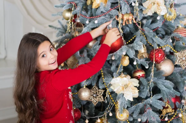 Decorate christmas tree. happy little girl celebrate winter holiday. happy new year. christmas time. Cute little child girl with xmas present. delivery christmas gifts. Enjoying New Year party Royalty Free Stock Photos