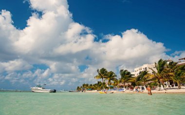 Costa Maya, Meksika-2 Şubat 2017: tropikal yaz tatil plaj ile deniz ya da okyanus su yeşil palmiye ağaçları, insanlar ve şemsiye kum sahil güneşli Costa Maya, Meksika açık mavi gökyüzü