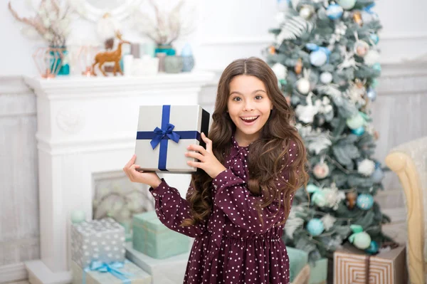 Cute little child girl with xmas present. The morning before Xmas. christmas family holiday. happy new year. Christmas shopping. waiting for santa. Winter. Have a holly jolly Christmas