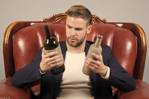 Guy choose wine to drink, choice