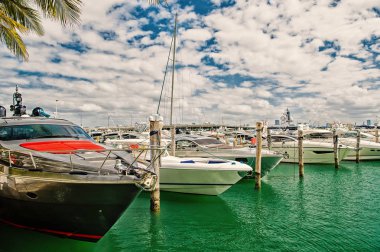 Lüks Yatlar Port Bay'de güneşli gün bulutlu Miami mavi gökyüzü üzerinde demirledi