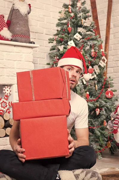 Man santa with boxes at christmas tree