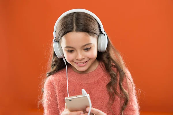 Best music apps for free. Enjoy perfect sound. Girl child listen music modern headphones and smartphone. Listen for free. Get music account subscription. Access to millions songs. Enjoy music concept