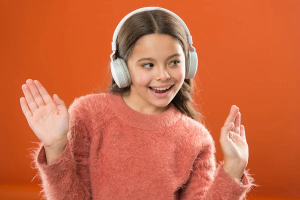 Girl child listen music modern wireless headphones. Listen for free. Get music account subscription. Access to millions songs. Enjoy music concept. Keep hands free with wireless modern technology — Stock Photo, Image