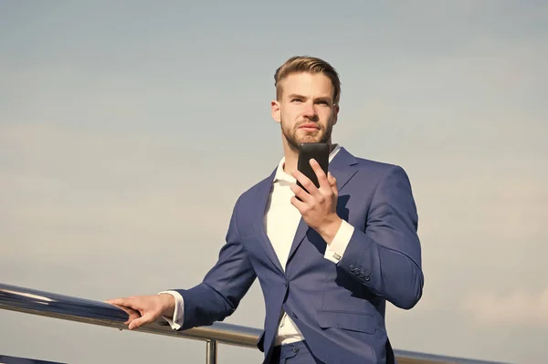 Forretningsfører i jakkesæt med mobiltelefon, ny teknologi - Stock-foto
