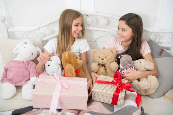 Dont open till Christmas. Cute little girls with presents in bed. Happy little children hold gift boxes. Opening presents on Christmas morning. New Year surprise. Merry Christmas and Happy New Year — Stock Photo, Image