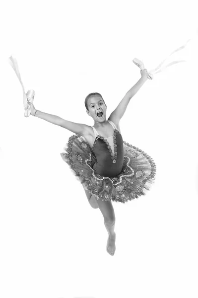 Child happy holds ballet shoes important attribute excellent ballerina. Girl ballerina holds pointe shoes in hand white background. Classic dance hobby favorite activity. Born to become famous dancer — Stock Photo, Image