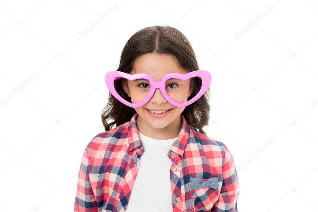Childhood love concept. Child charming smile fall in love. Girl heart shaped eyeglasses celebrates valentines day. Girl cute kid smiling face heart eyeglasses. Love symbol concept. Fall in love