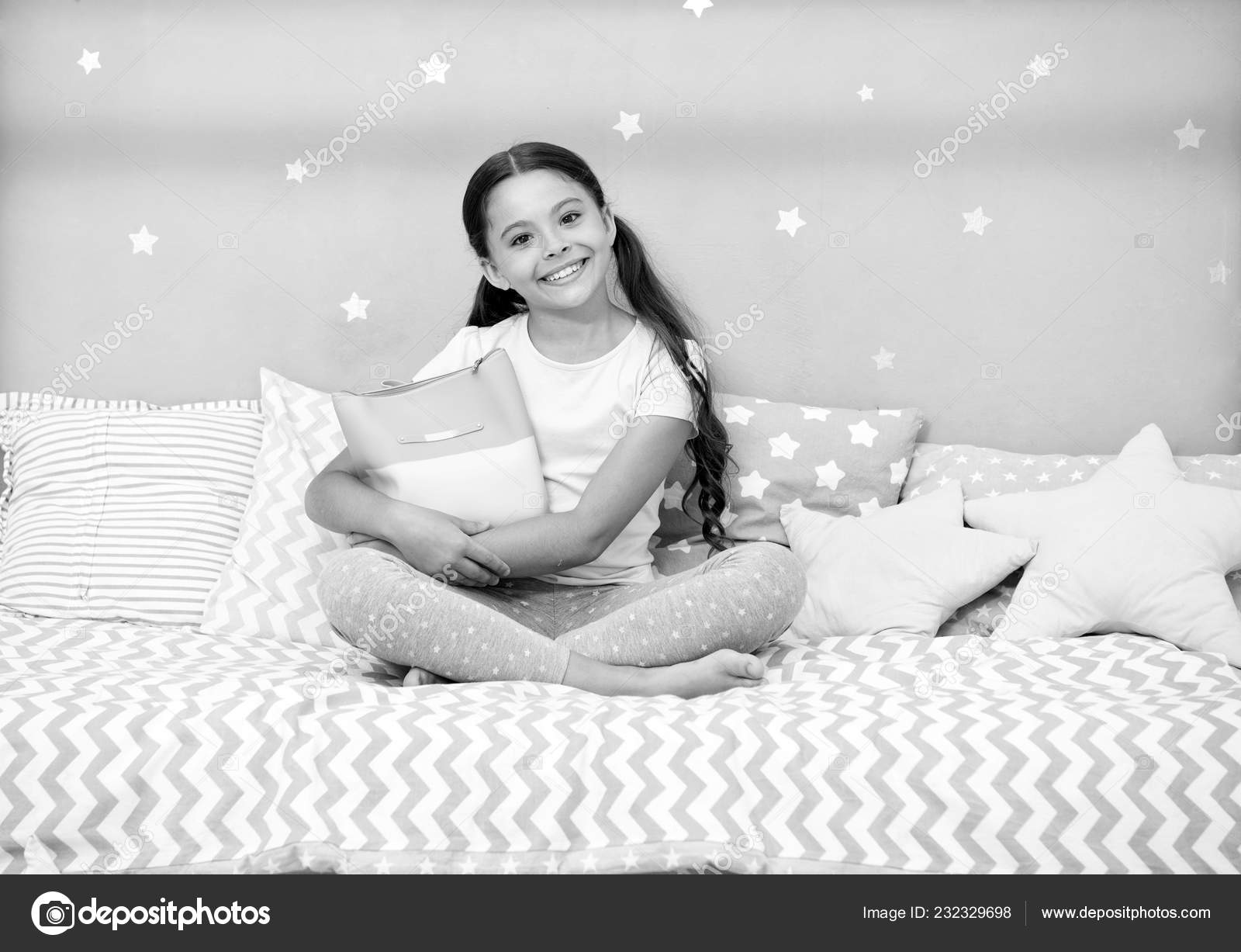 Girlish secrets. Girl child sit on bed with bag or cosmetics bag in her