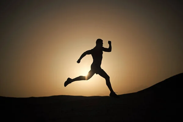 Correndo silhueta homem no céu por do sol — Fotografia de Stock