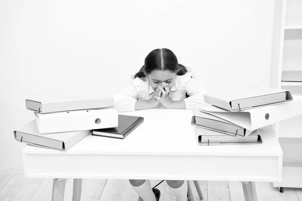 So nervous about coming test. Girl child reads book while sit table white background. Schoolgirl studying prepare for test or exam. Kid girl school uniform nervous about coming test check knowledge