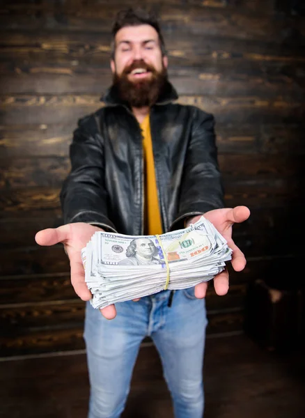 Illegal profit and black cash. Guy mafia dealer with cash profit. Man brutal bearded hipster wear leather jacket and hold cash money. Man give cash money bribe. Richness and wellbeing. Mafia business — Stock Photo, Image