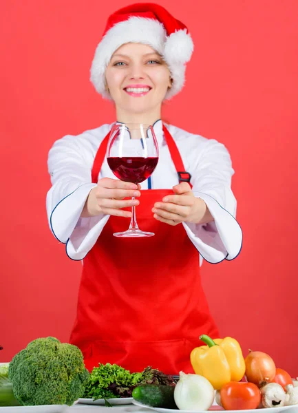 No stress. Best christmas recipes. Enjoy easy ideas for holiday parties and holiday dinners. Festive menu concept. Christmas dinner ideas. Christmas menu. Woman chef cooking wear santa hat drink wine