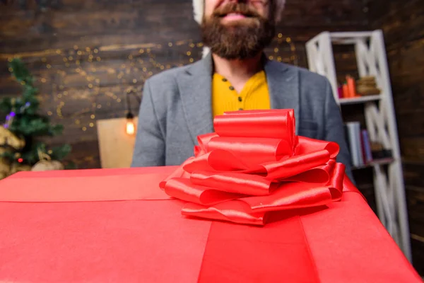 This is for you. Man santa deliver gift. Bearded guy carry present box close up. Delivery christmas present. Delivery service. Deliver happiness and joy. Christmas is coming. Courier giving gift