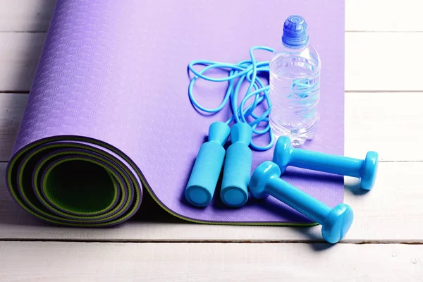 Dumbbells and jump rope in cyan blue color