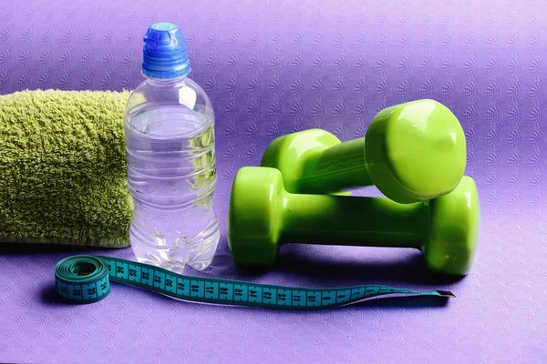 Healthy shape and sport concept. Dumbbells made of green plastic