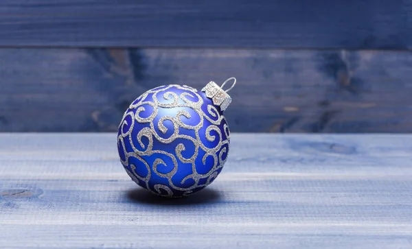 Symbol of new year and christmas holidays. Celebrate christmas. Christmas ball decoration on blue vintage wooden background. Winter holiday concept. Decorate christmas tree with traditional toys — Stock Photo, Image