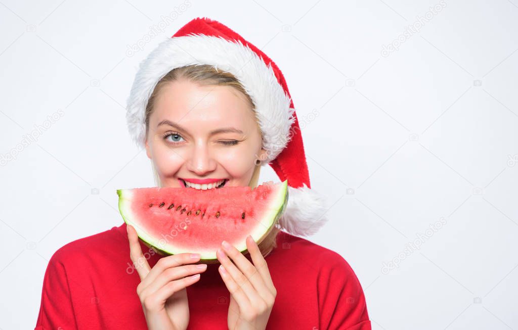 Christmas girl eat watermelon. Woman santa hat hold slice watermelon. Prolong summer. Travel christmas vacation and holidays resort. Tropical christmas concept. Christmas summer destinations