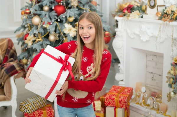 Surprise. Child enjoy the holiday. Christmas tree and presents. Happy new year. Winter. xmas online shopping. Family holiday. The morning before Xmas. Little girl