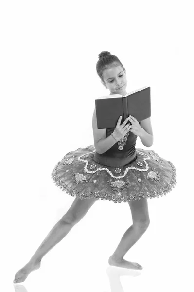 Depriving children ballerina. Most of time child dancer spend in gym training and practicing performance. No time for school studying. Girl ballerina dancing while read book. Ballet career issues — Stock Photo, Image