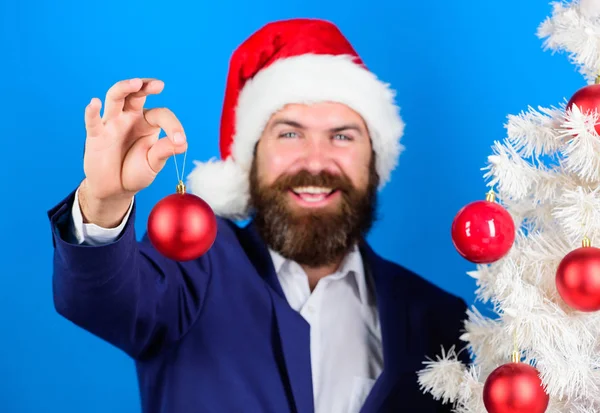 Businessman offer you join christmas preparation. Special christmas offer. Man bearded hipster wear formal suit and santa hat. Santa hold christmas ball decoration. Business and christmas concept — Stock Photo, Image